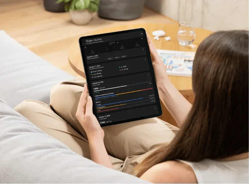 smartphone showing fitness app timeline feed with workout entries, meal photos, and progress charts, modern UI design, vibrant colors